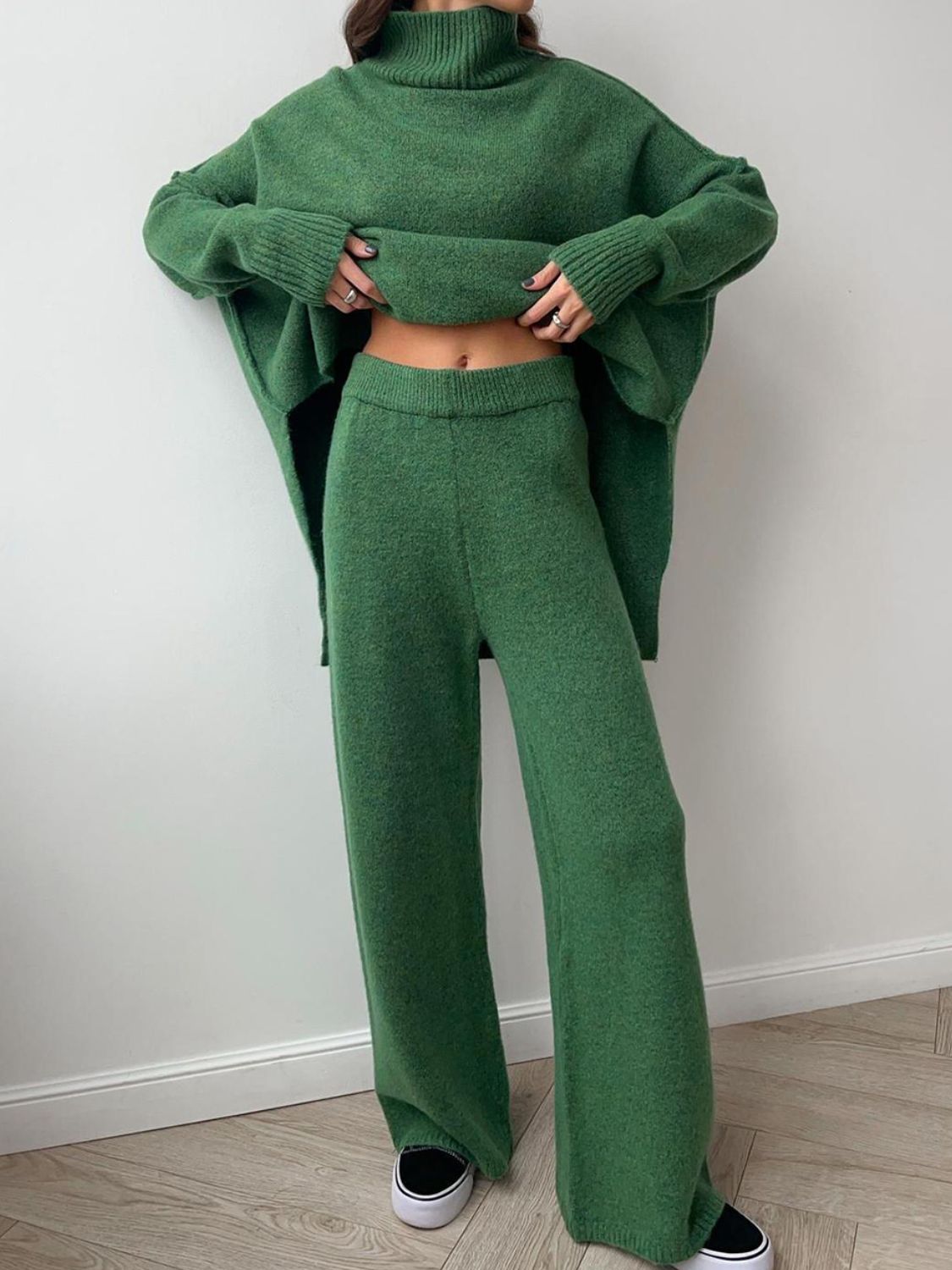 Green slit turtleneck long sleeve top and pants sweater set with moderate stretch.